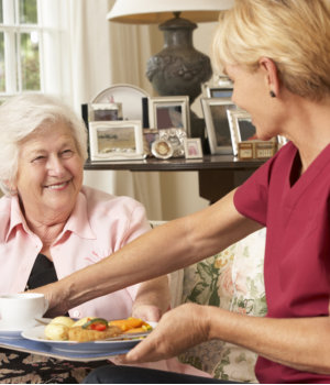 caregiver preparing meal to her patient